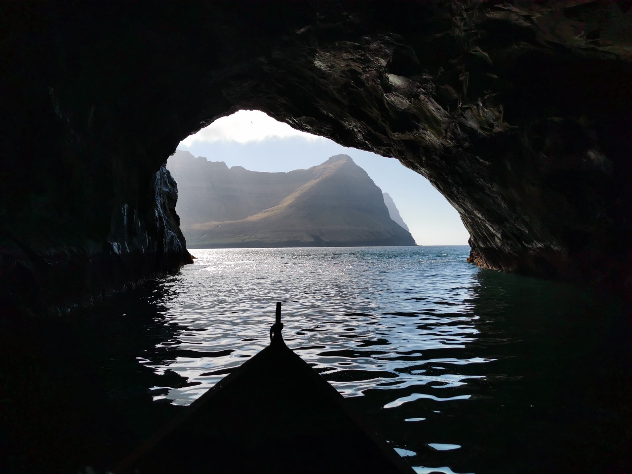 Sailing into sea cave by Viðareiði